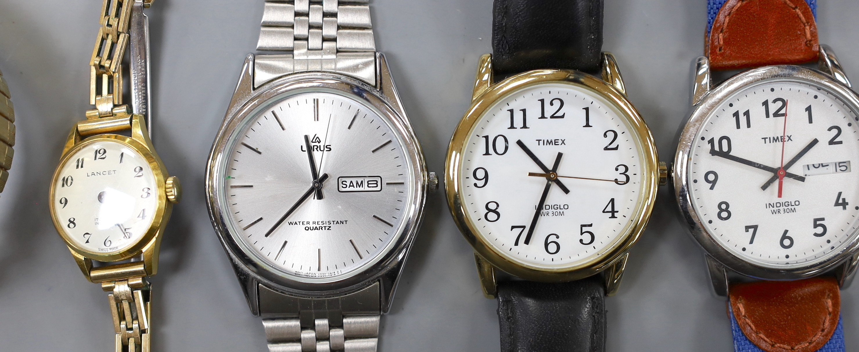 A lady's yellow metal Omega manual wind wrist watch and a group of assorted wrist watch including Lorus, Timex etc.